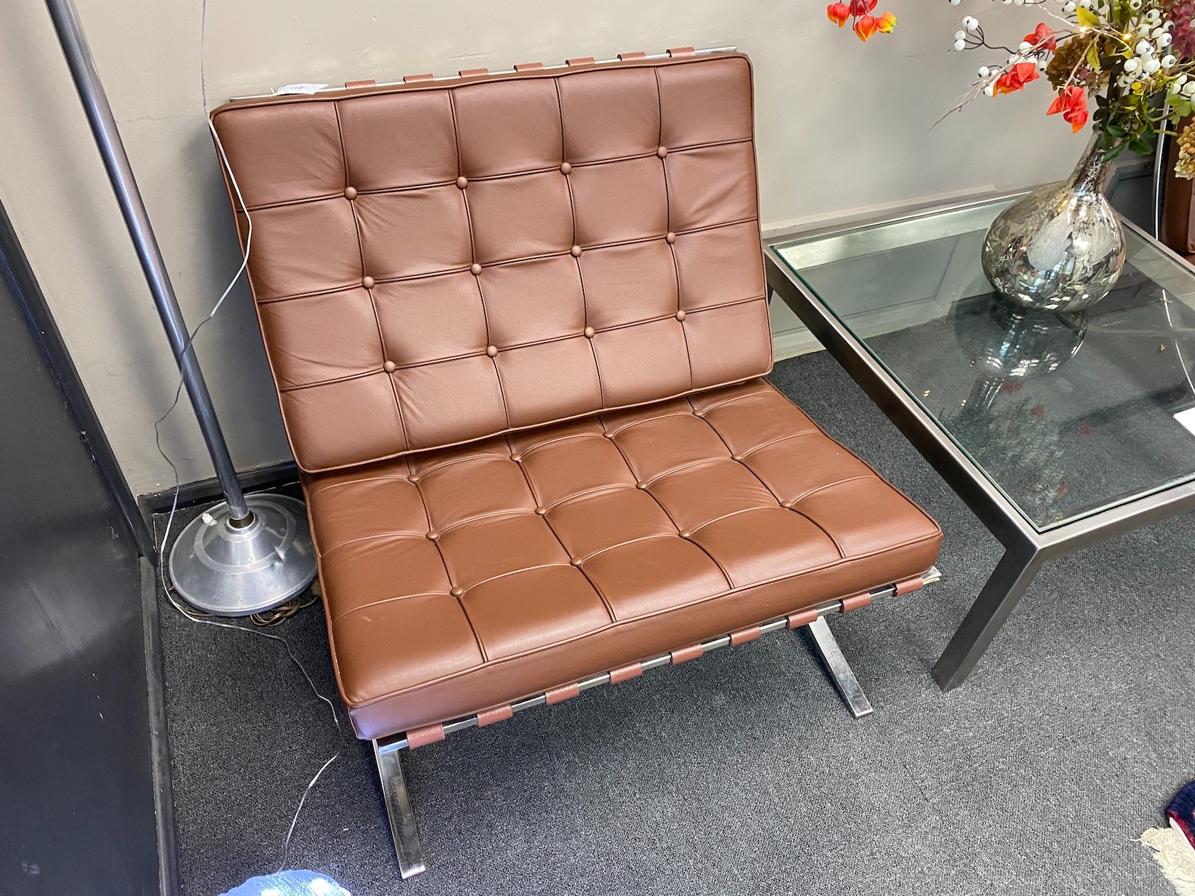A pair of Barcelona style brown leather and chrome chairs, width 76cm, depth 78cm, height 73cm